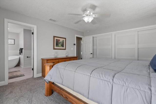 44850 E 43rd St, Lancaster, CA 93535 - bedroom featuring carpet flooring, ensuite bathroom, a textured ceiling, a ceiling fan, and baseboards