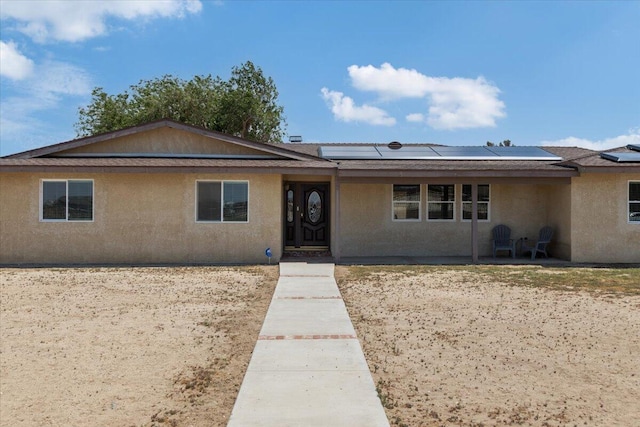 44850 E 43rd St, Lancaster, CA 93535 - single story home featuring solar panels and stucco siding