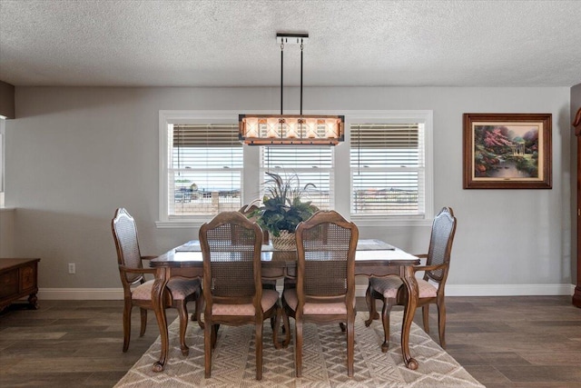 44850 E 43rd St, Lancaster, CA 93535 - dining room featuring dark wood-type flooring, healthy amount of natural light, baseboards, and a textured ceiling
