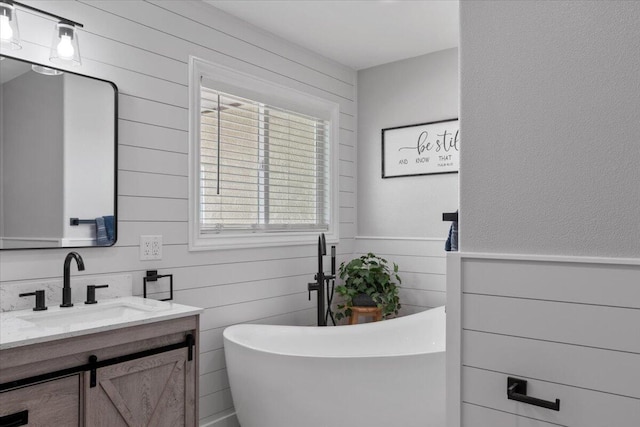 44850 E 43rd St, Lancaster, CA 93535 - bathroom with vanity, a soaking tub, wooden walls, and wainscoting