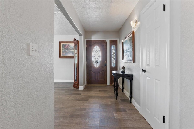 44850 E 43rd St, Lancaster, CA 93535 - entryway featuring a textured wall, dark wood-type flooring, a textured ceiling, and baseboards