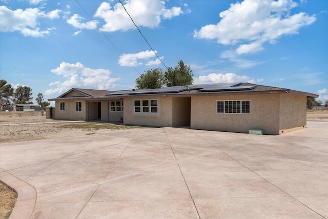 44850 E 43rd St, Lancaster, CA 93535 - rear view of house featuring stucco siding and solar panels