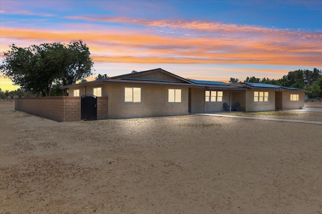 44850 E 43rd St, Lancaster, CA 93535 - ranch-style home with solar panels, fence, and a gate