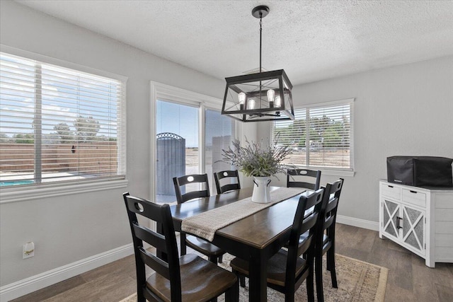 44850 E 43rd St, Lancaster, CA 93535 - dining space with a chandelier, a textured ceiling, dark wood-type flooring, and baseboards