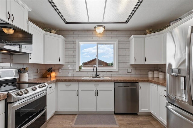 44850 E 43rd St, Lancaster, CA 93535 - kitchen featuring appliances with stainless steel finishes, a sink, white cabinetry, and decorative backsplash