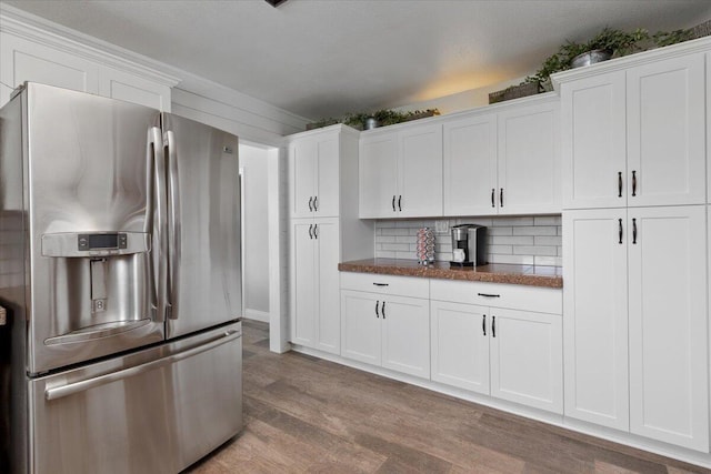 44850 E 43rd St, Lancaster, CA 93535 - kitchen featuring stainless steel fridge with ice dispenser, wood finished floors, white cabinetry, and tasteful backsplash