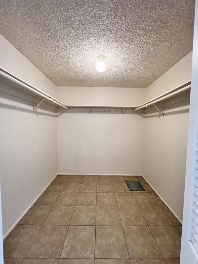 walk in closet featuring tile patterned flooring