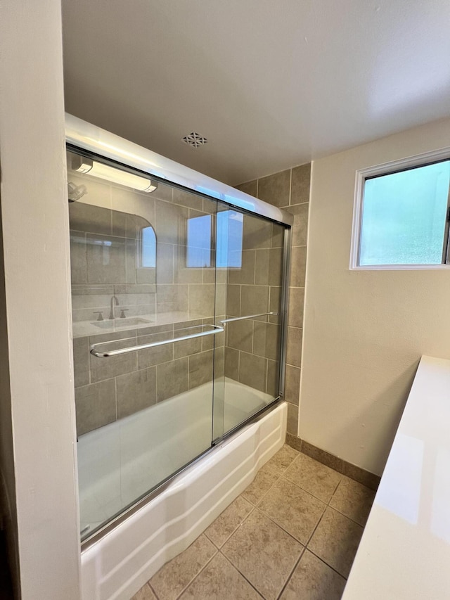 bathroom with tile patterned floors and combined bath / shower with glass door