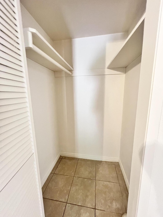 walk in closet featuring light tile patterned flooring