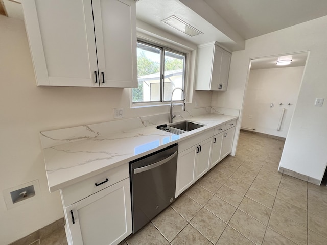 kitchen featuring dishwasher, light stone counters, white cabinetry, and sink