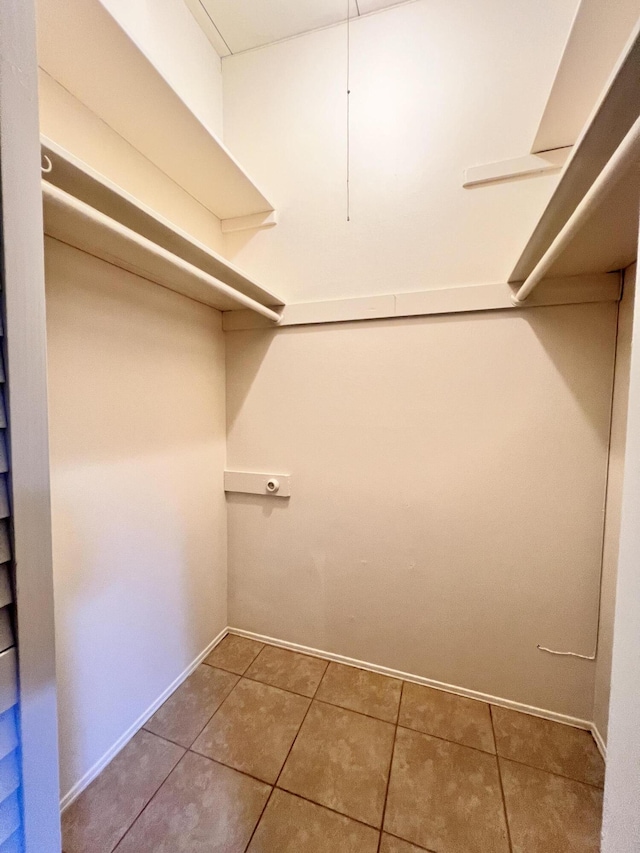 spacious closet featuring tile patterned flooring