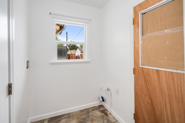 44251 Date Ave, Lancaster, CA 93534 - laundry room with stone finish flooring, hookup for a washing machine, baseboards, and laundry area