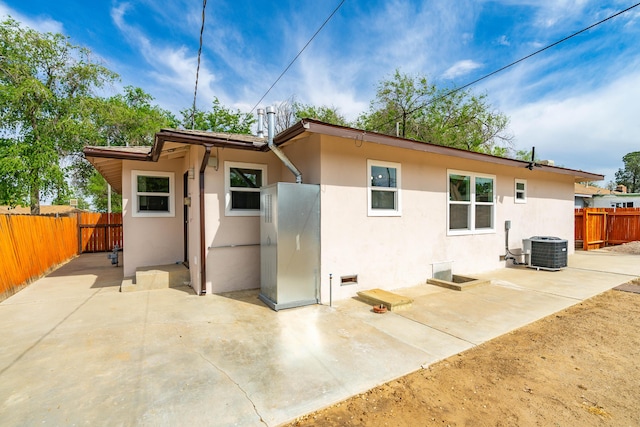 44251 Date Ave, Lancaster, CA 93534 - back of house with a patio area, central AC unit, stucco siding, and fence