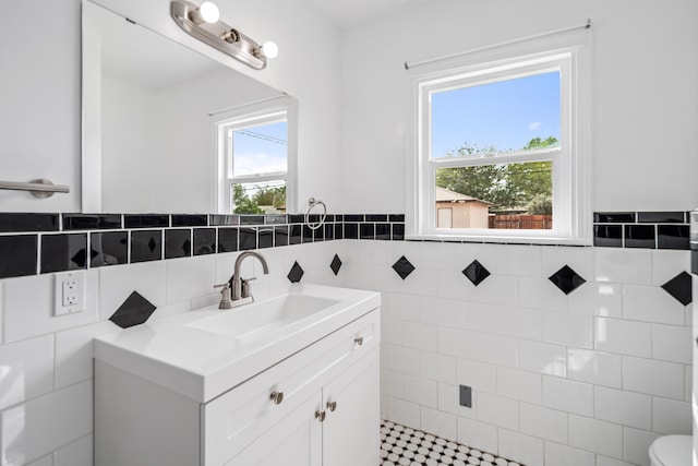 44251 Date Ave, Lancaster, CA 93534 - bathroom featuring tile walls, toilet, vanity, and wainscoting