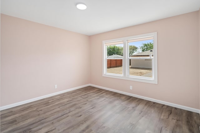 44251 Date Ave, Lancaster, CA 93534 - empty room with wood finished floors and baseboards