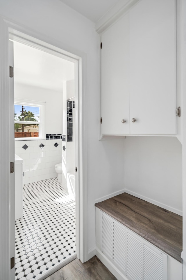 44251 Date Ave, Lancaster, CA 93534 - bathroom with toilet, vanity, and tile walls
