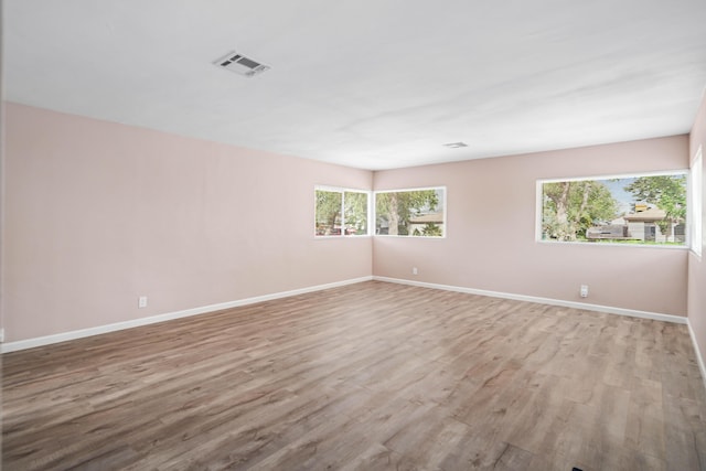 44251 Date Ave, Lancaster, CA 93534 - spare room with visible vents, plenty of natural light, and wood finished floors