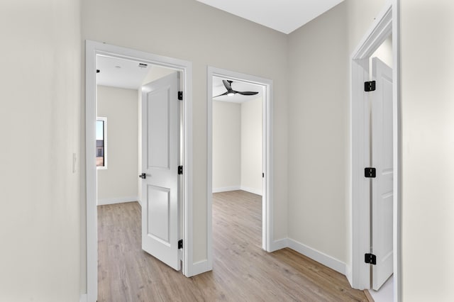 hallway with light hardwood / wood-style flooring