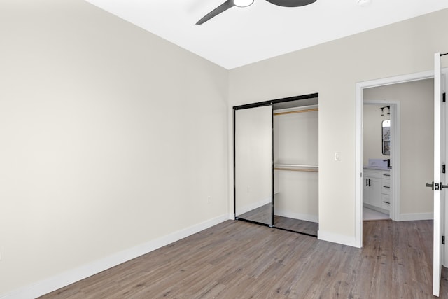 unfurnished bedroom with ceiling fan, light hardwood / wood-style floors, and a closet