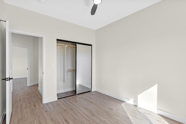 unfurnished bedroom with a closet, ceiling fan, and light wood-type flooring