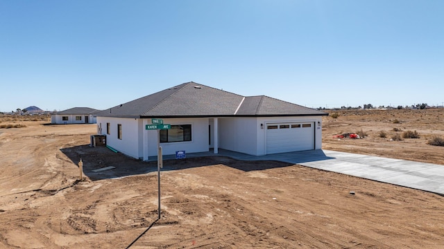 view of front of property with central air condition unit and a garage