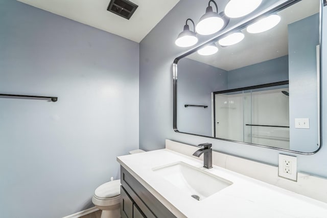 bathroom featuring visible vents, vanity, and toilet