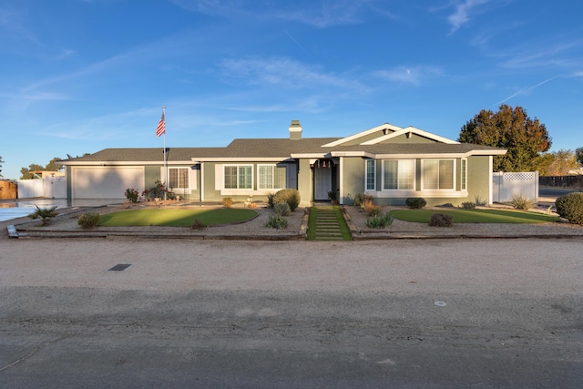 ranch-style home featuring a front yard and a garage