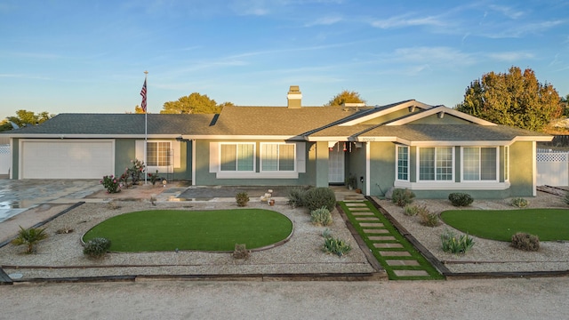 ranch-style home featuring a garage and a front yard