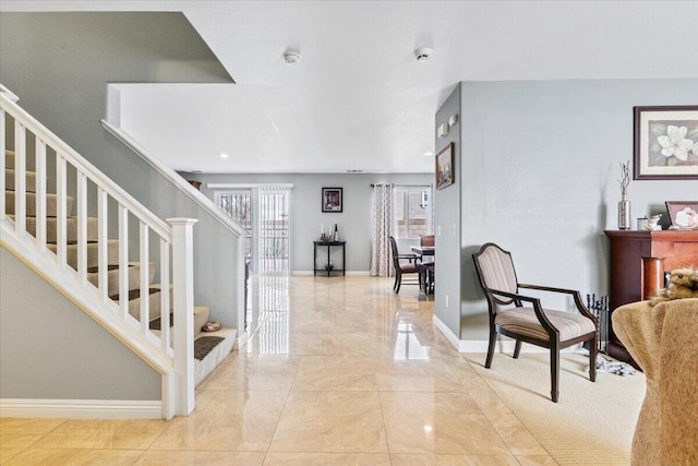 interior space with baseboards, marble finish floor, and stairs