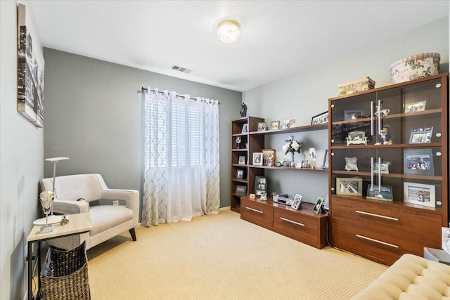 sitting room featuring visible vents and carpet