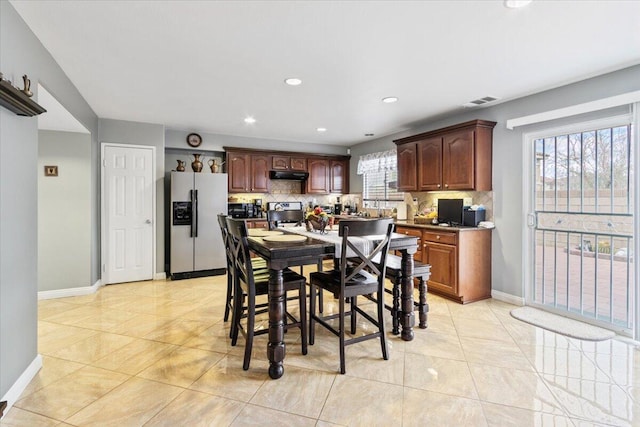 dining space featuring visible vents, light tile patterned floors, recessed lighting, and baseboards