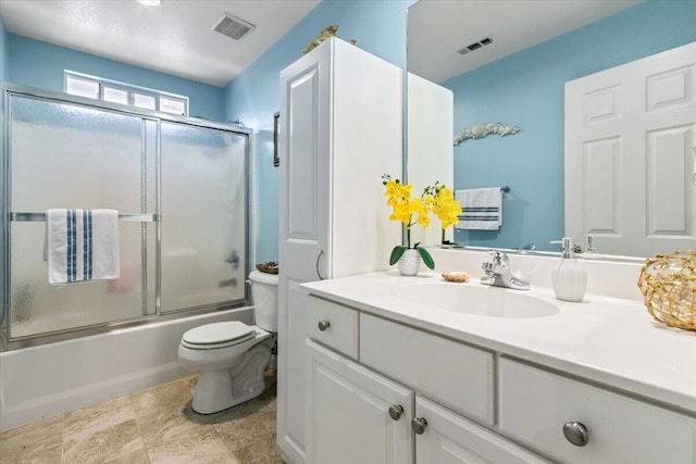 bathroom with combined bath / shower with glass door, visible vents, toilet, and vanity