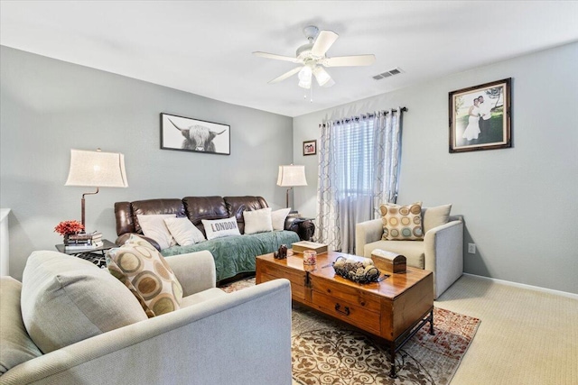 carpeted living area featuring visible vents, baseboards, and ceiling fan