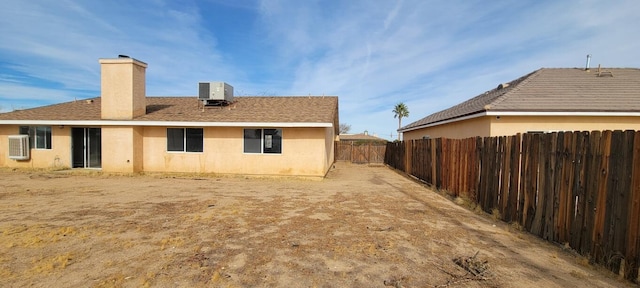 rear view of house with central air condition unit