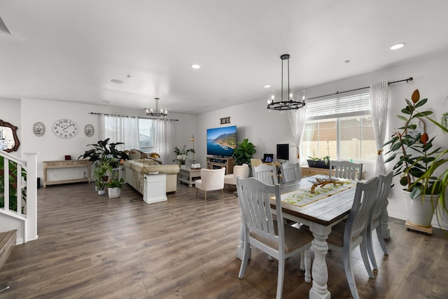 dining space with an inviting chandelier, dark wood-type flooring, and recessed lighting