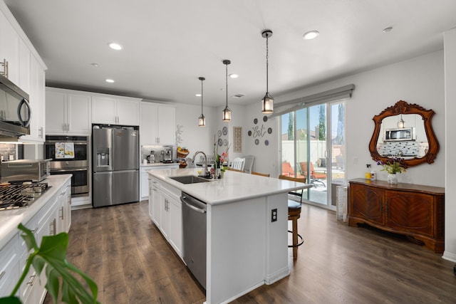 kitchen featuring recessed lighting, light countertops, appliances with stainless steel finishes, and a sink