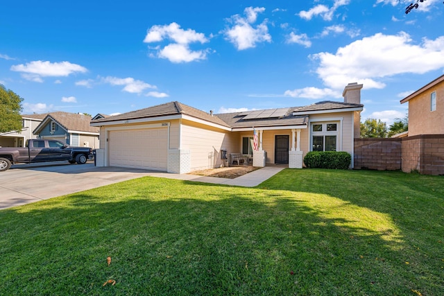 view of front of property with a garage, a front yard, and solar panels