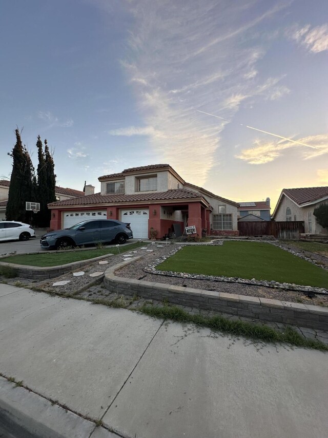 37847 Tacksteam St, Palmdale, CA 93552 - traditional home with an attached garage, a tile roof, and driveway