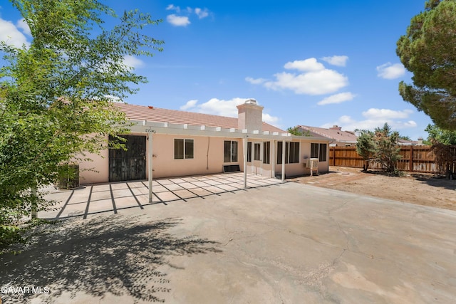 44242 Brandon Thomas Way, Lancaster, CA 93536 - rear view of house featuring a sunroom, a patio area, stucco siding, a chimney, and a tiled roof