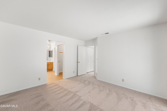 44242 Brandon Thomas Way, Lancaster, CA 93536 - unfurnished bedroom with light colored carpet and ensuite bath