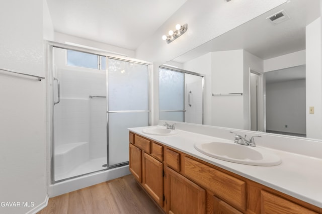44242 Brandon Thomas Way, Lancaster, CA 93536 - full bath featuring wood finished floors, a shower stall, and double vanity