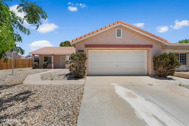 44242 Brandon Thomas Way, Lancaster, CA 93536 - view of front facade featuring an attached garage, driveway, stucco siding, and a tile roof