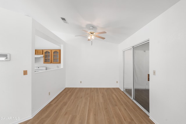44242 Brandon Thomas Way, Lancaster, CA 93536 - spare room featuring washer / dryer, ceiling fan, and light wood-style flooring