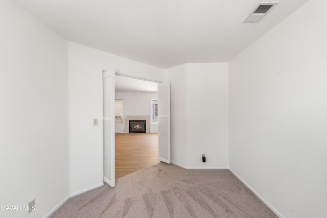 44242 Brandon Thomas Way, Lancaster, CA 93536 - carpeted spare room with a tiled fireplace and baseboards