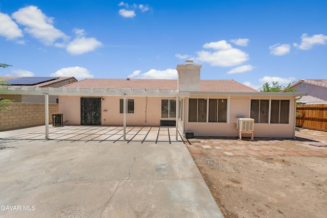 44242 Brandon Thomas Way, Lancaster, CA 93536 - rear view of property with a chimney, a patio, a sunroom, a tiled roof, and stucco siding