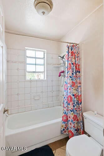 43667 Park Ave, Lancaster, CA 93534 - full bathroom with healthy amount of natural light, tile patterned flooring, and shower / bathtub combination with curtain