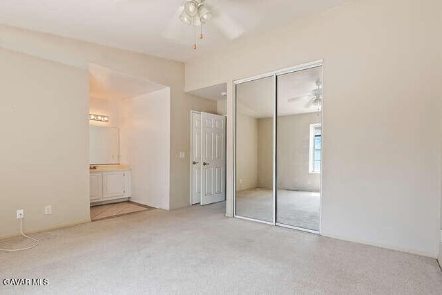 43667 Park Ave, Lancaster, CA 93534 - unfurnished bedroom featuring light colored carpet, ensuite bathroom, and multiple closets