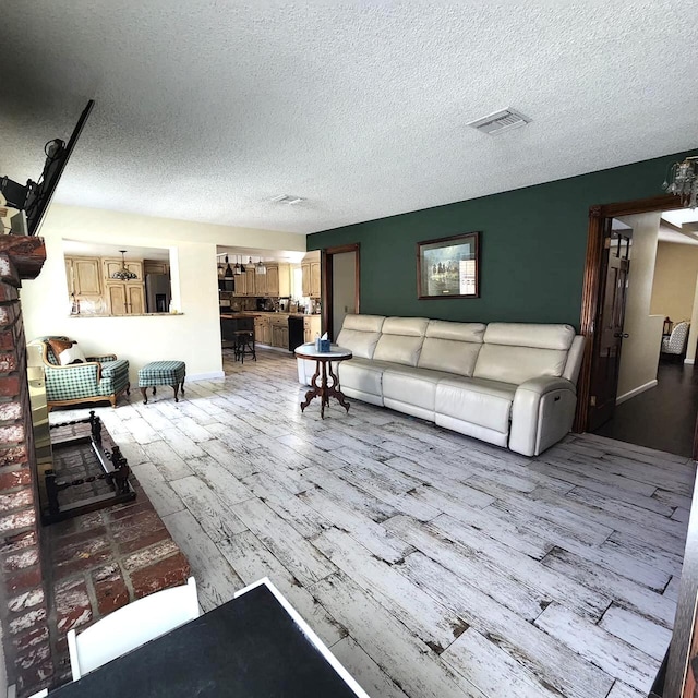 living room with hardwood / wood-style floors and a textured ceiling