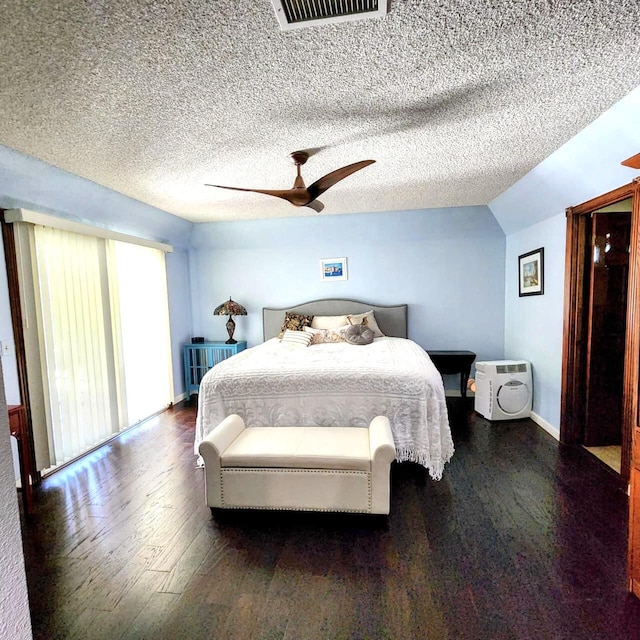 bedroom with a textured ceiling, dark hardwood / wood-style floors, vaulted ceiling, and ceiling fan