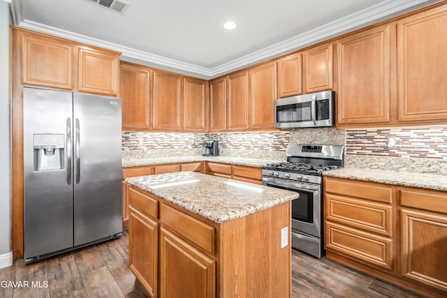 42638 Meridian Way, Lancaster, CA 93536 - kitchen featuring appliances with stainless steel finishes, a center island, dark wood-type flooring, light stone countertops, and recessed lighting